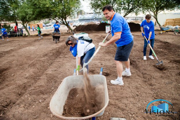 NAI Horizon's Jeff Adams shovels dirt at the 2017 Valley Partnership Community Project.